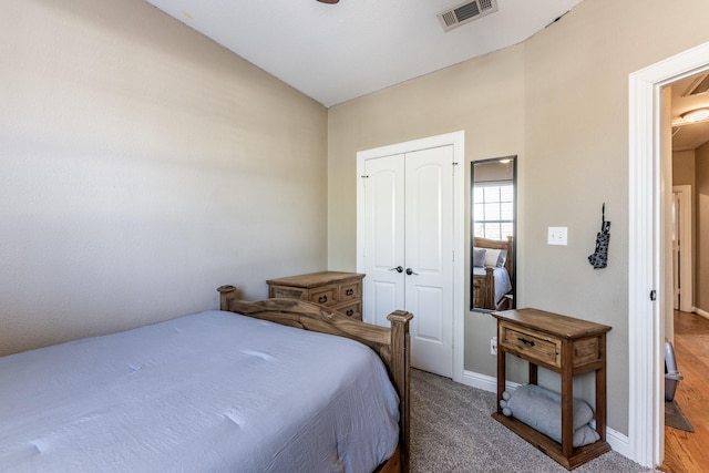 bedroom featuring vaulted ceiling, carpet floors, and a closet