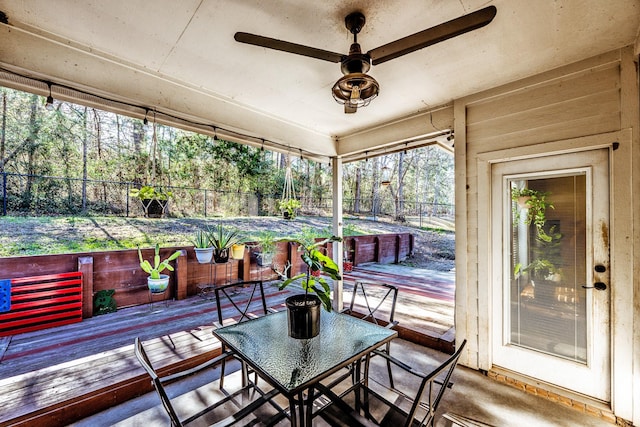 sunroom / solarium featuring ceiling fan