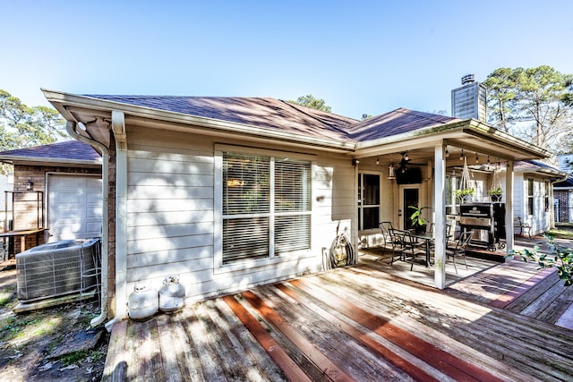 wooden deck featuring central AC and ceiling fan