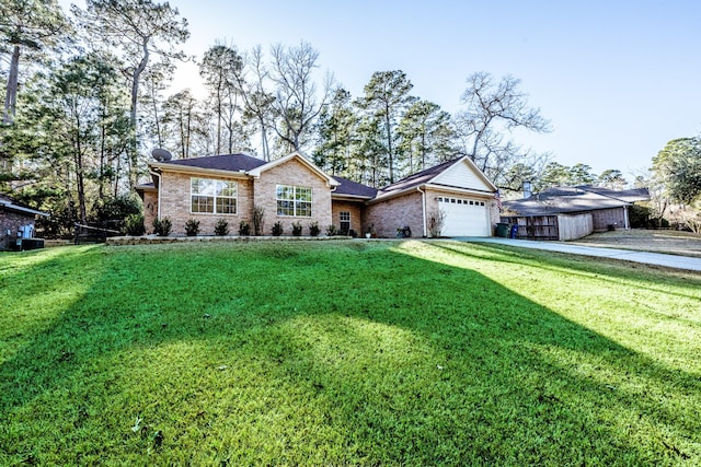 single story home with a garage and a front lawn