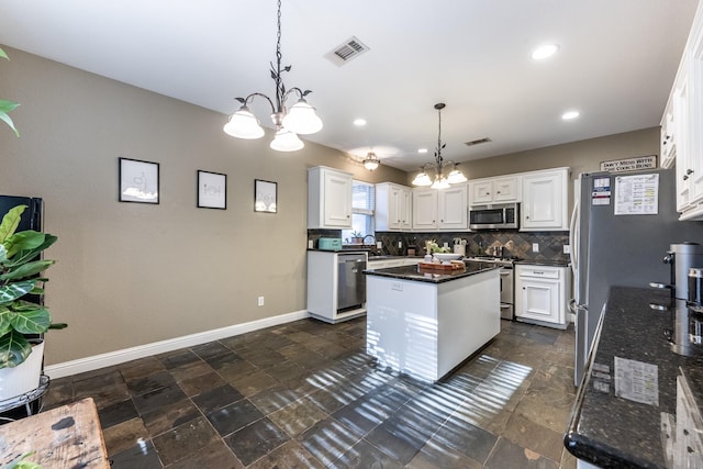 kitchen featuring a kitchen island, white cabinetry, appliances with stainless steel finishes, and decorative light fixtures