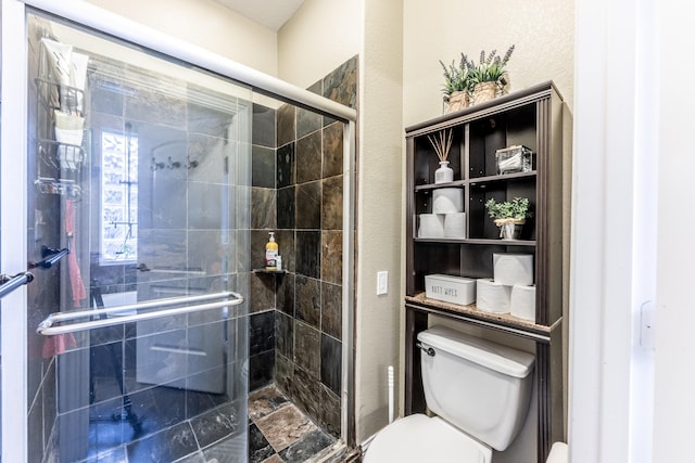 bathroom featuring toilet and an enclosed shower