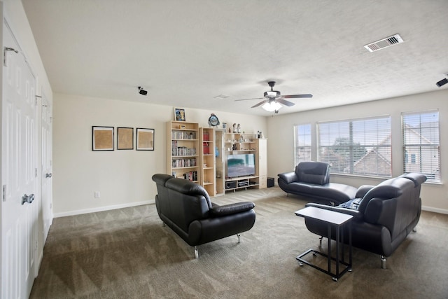 carpeted living room featuring a textured ceiling and ceiling fan