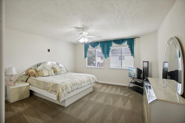 carpeted bedroom with ceiling fan and a textured ceiling