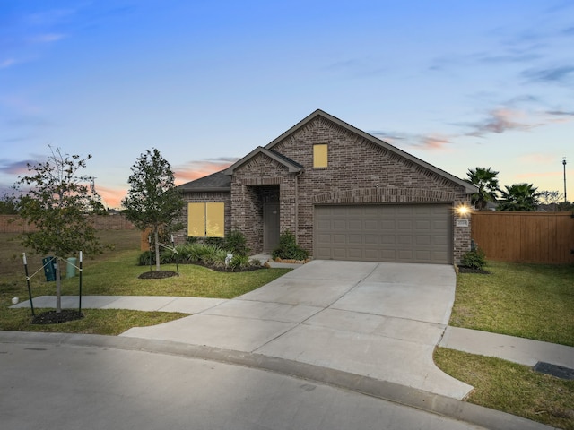 view of front of property with a yard and a garage