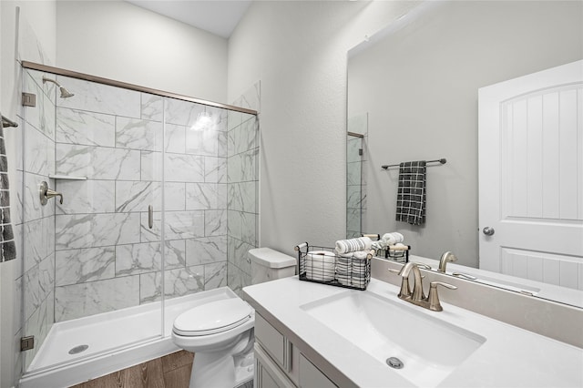 bathroom featuring hardwood / wood-style flooring, vanity, an enclosed shower, and toilet