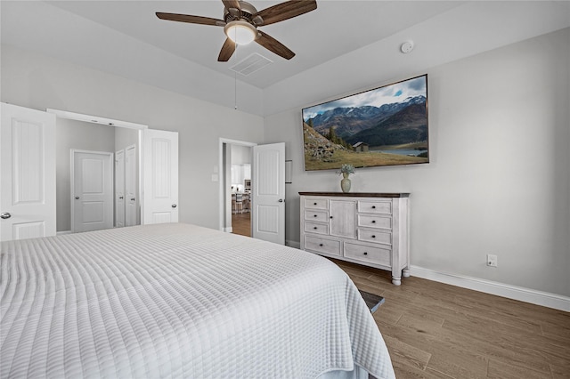 bedroom with wood-type flooring, lofted ceiling, and ceiling fan