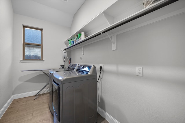 laundry area featuring light hardwood / wood-style floors and washer and dryer