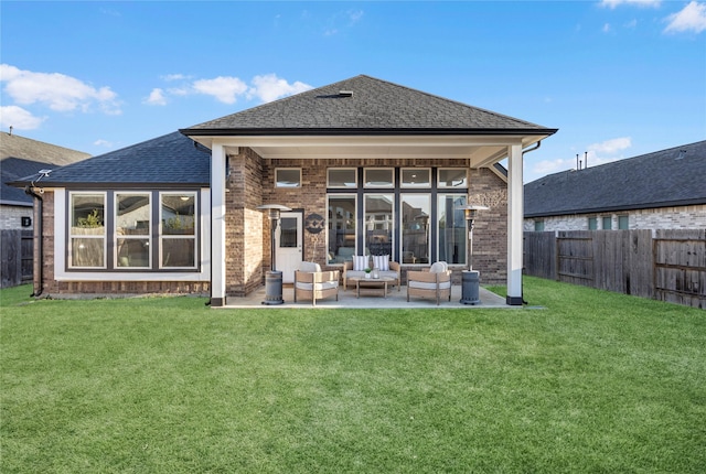 rear view of property featuring an outdoor living space, a yard, and a patio area