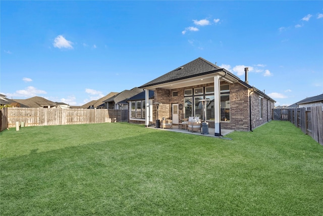 rear view of property featuring a patio area and a lawn