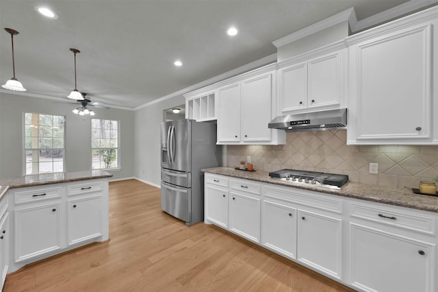 kitchen featuring light stone countertops, white cabinetry, appliances with stainless steel finishes, and crown molding