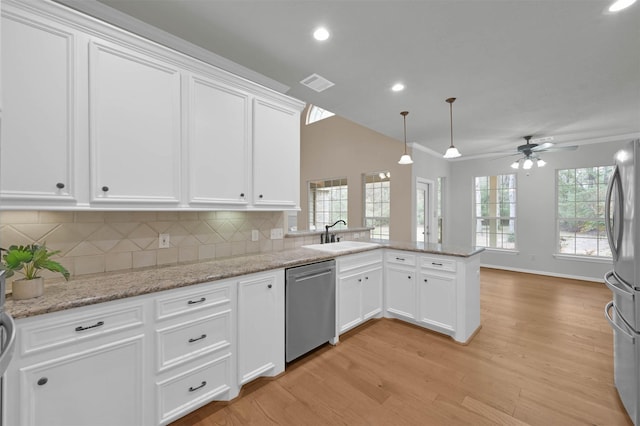 kitchen with white cabinetry, appliances with stainless steel finishes, sink, and kitchen peninsula