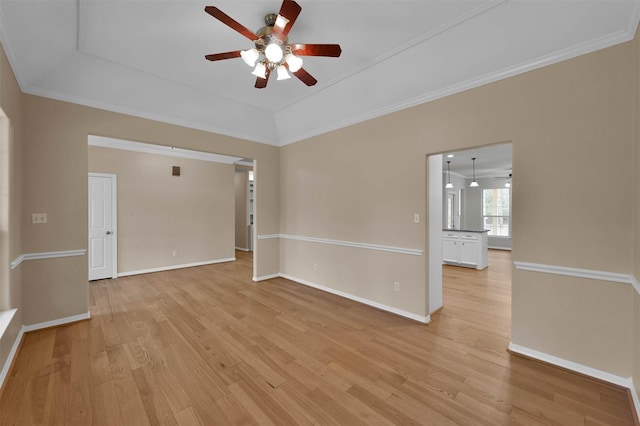 spare room featuring ornamental molding, ceiling fan, and light wood-type flooring