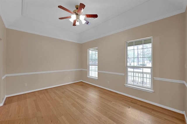 spare room with light hardwood / wood-style flooring, ornamental molding, a raised ceiling, and ceiling fan