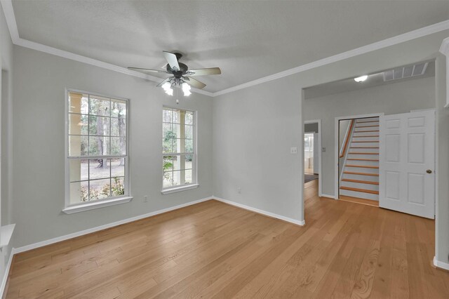 spare room featuring ceiling fan, ornamental molding, and light hardwood / wood-style flooring