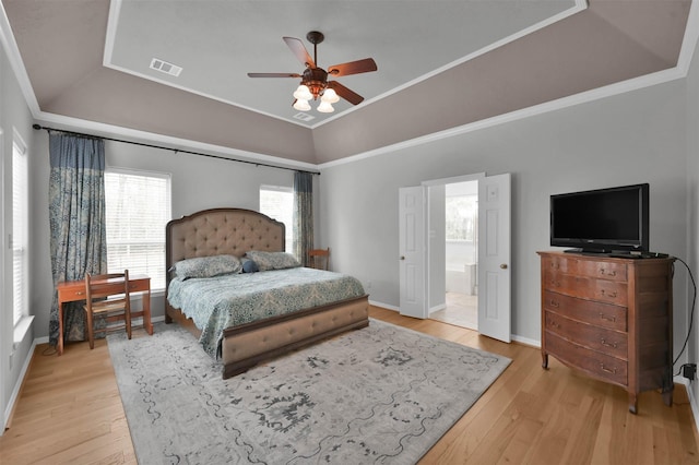 bedroom featuring crown molding, lofted ceiling, and light hardwood / wood-style floors
