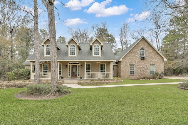 cape cod house with a porch and a front lawn