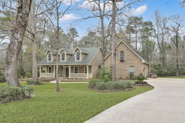 new england style home with covered porch and a front lawn