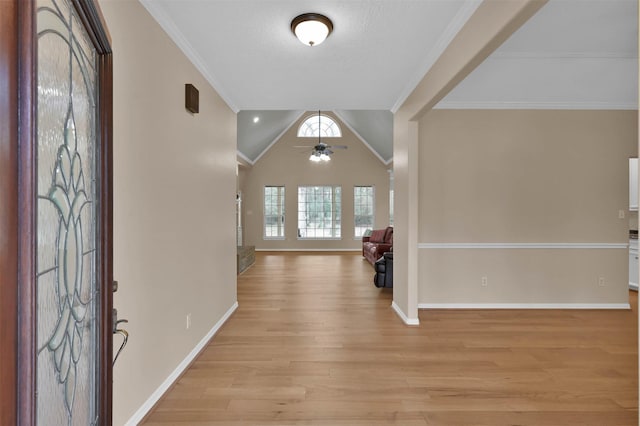 foyer entrance with lofted ceiling, crown molding, ceiling fan, a textured ceiling, and light wood-type flooring