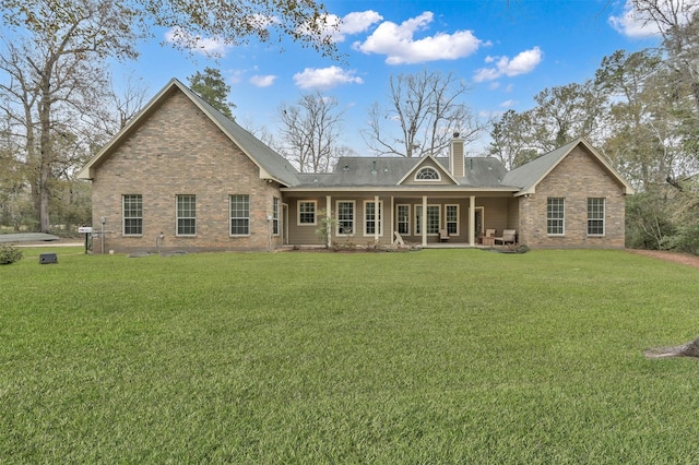 rear view of property featuring a yard
