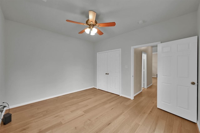 unfurnished bedroom with ceiling fan, light hardwood / wood-style floors, and a closet