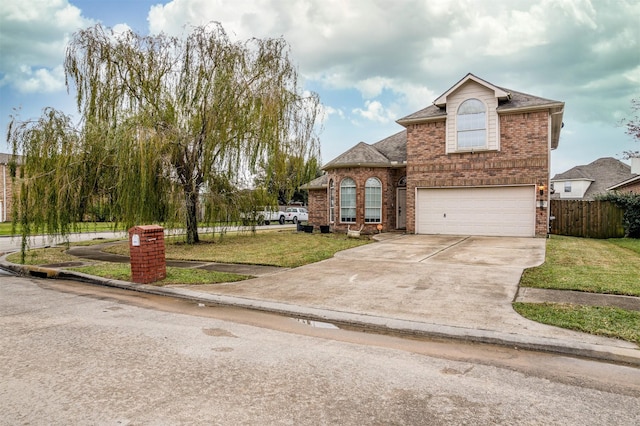 view of property featuring a garage and a front lawn