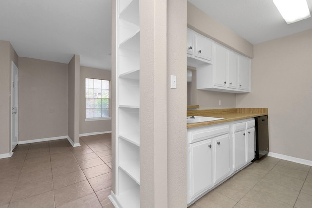 kitchen featuring white cabinetry, sink, and light tile patterned floors