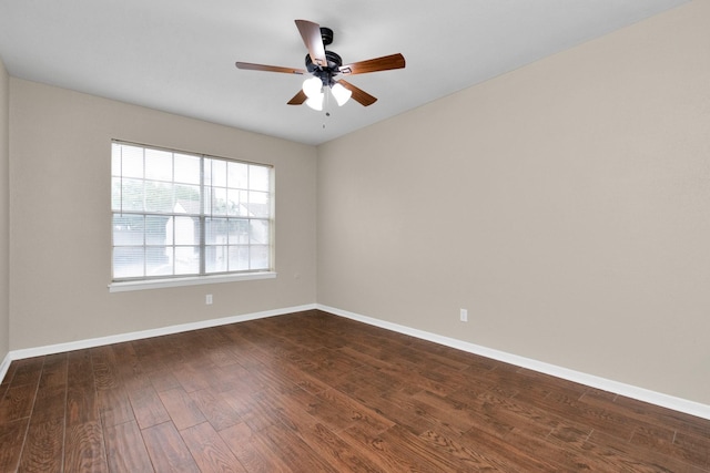 empty room with dark wood-type flooring and ceiling fan