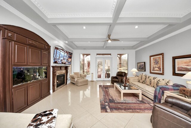 tiled living room with coffered ceiling, a high end fireplace, beam ceiling, and french doors