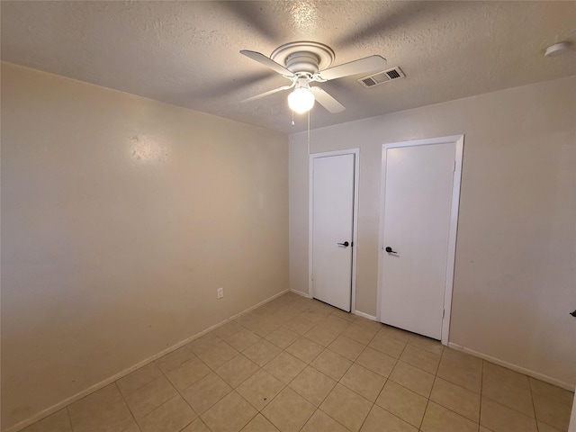 unfurnished bedroom with a textured ceiling and ceiling fan