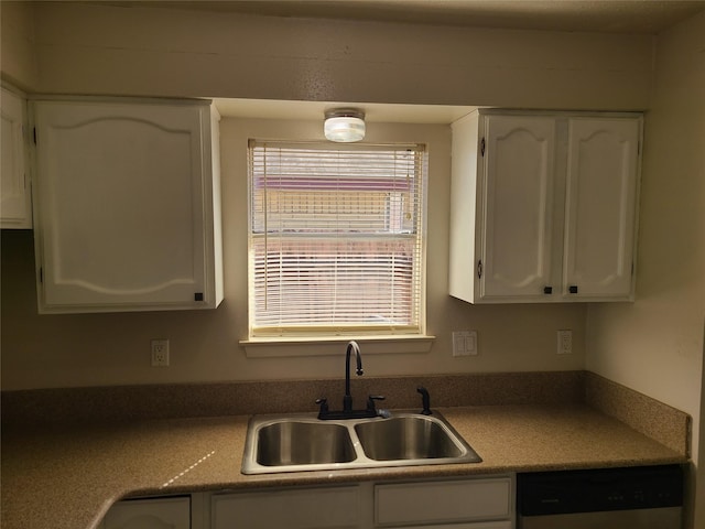 kitchen featuring white cabinetry, stainless steel dishwasher, and sink