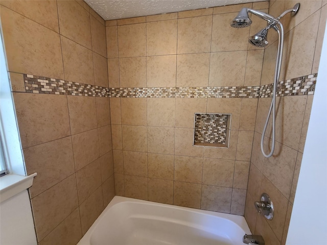 bathroom featuring tiled shower / bath combo and a textured ceiling