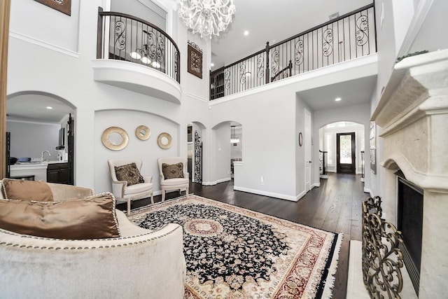 interior space with an inviting chandelier, dark hardwood / wood-style floors, and a high ceiling