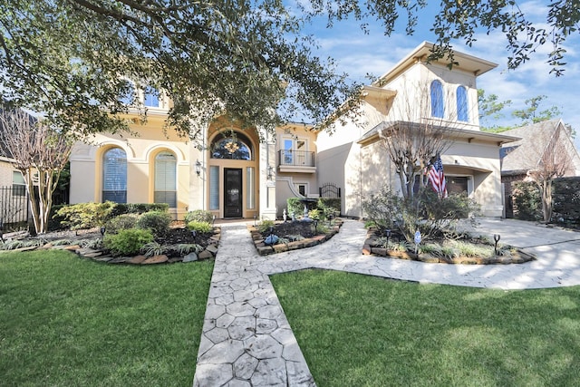 mediterranean / spanish-style house featuring a garage and a front yard