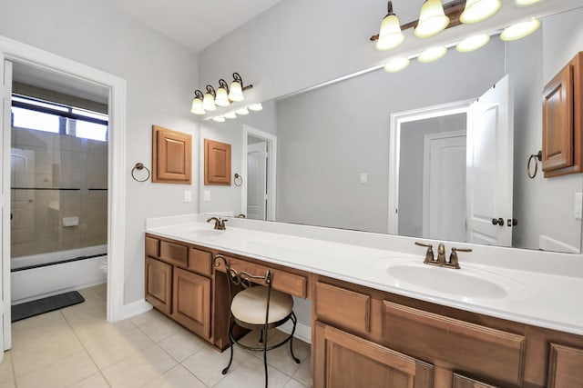 full bathroom featuring vanity, tile patterned floors, shower / bath combination with glass door, and toilet