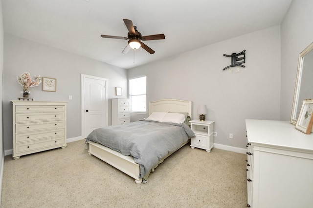 bedroom with ceiling fan and light carpet