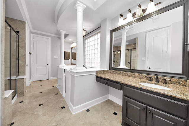 bathroom featuring ornate columns, vanity, ornamental molding, an enclosed shower, and tile patterned floors