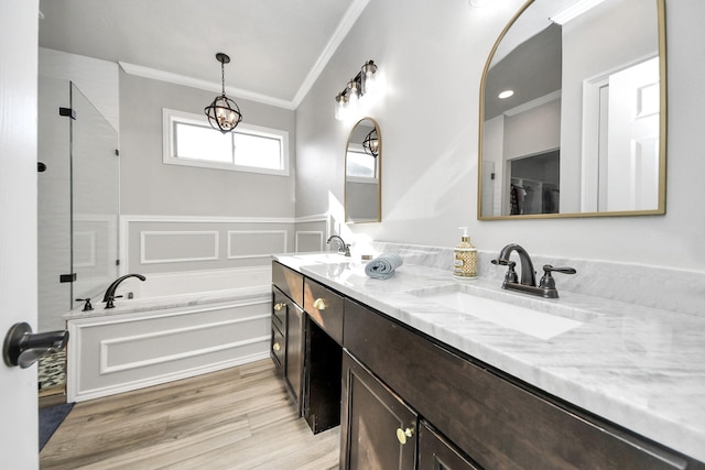 bathroom with crown molding, wood-type flooring, separate shower and tub, and vanity