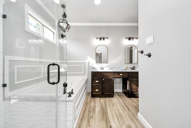 bathroom with vanity, hardwood / wood-style floors, ornamental molding, and independent shower and bath