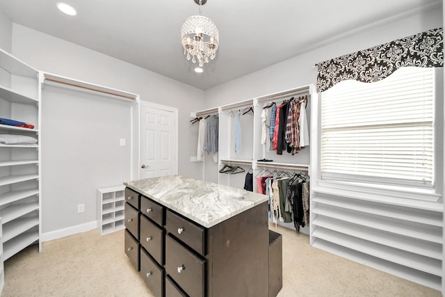 spacious closet featuring a notable chandelier