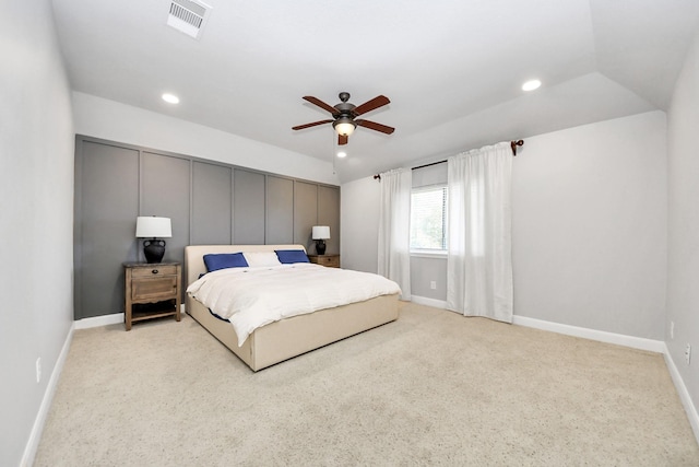 bedroom with ceiling fan, vaulted ceiling, and light carpet