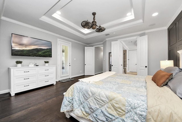 bedroom featuring a raised ceiling, crown molding, dark hardwood / wood-style floors, and access to exterior