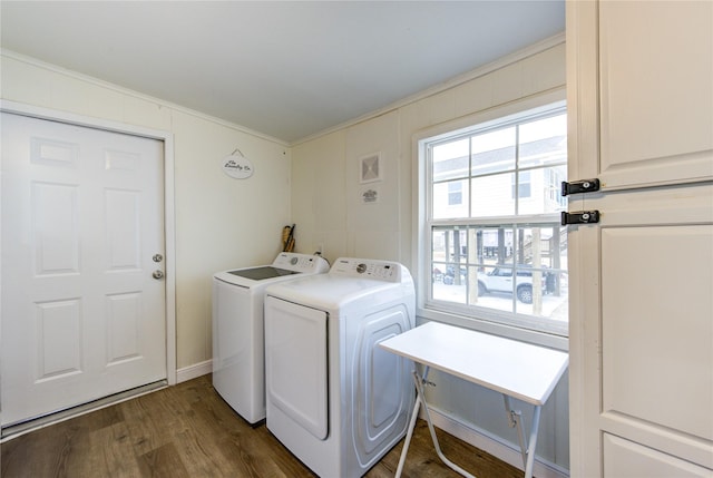 laundry room with dark wood-type flooring, crown molding, and washer and clothes dryer