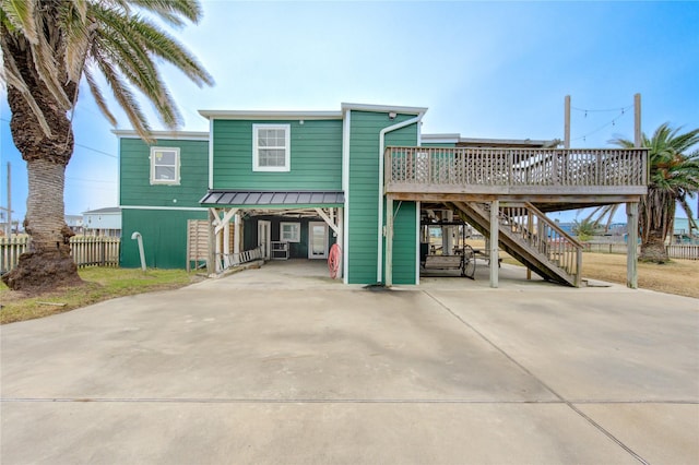 view of front of house featuring a carport and a deck