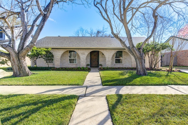 ranch-style home with a front lawn