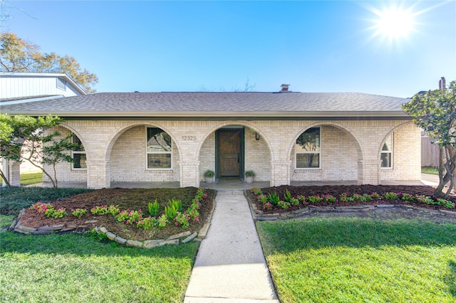 ranch-style house with a porch and a front yard