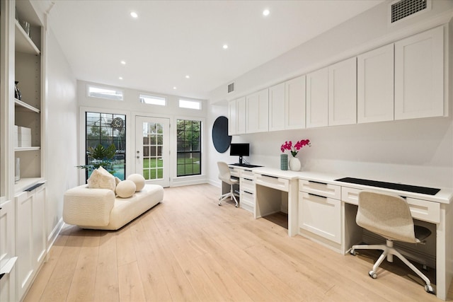 office featuring built in desk and light hardwood / wood-style flooring