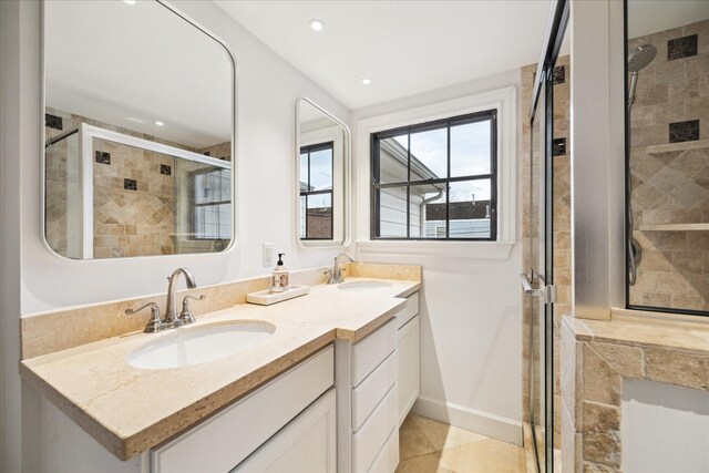 bathroom featuring tile patterned flooring, vanity, and an enclosed shower