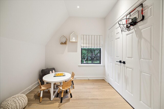 interior space with vaulted ceiling and light hardwood / wood-style floors