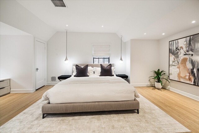 bedroom featuring vaulted ceiling and light hardwood / wood-style flooring